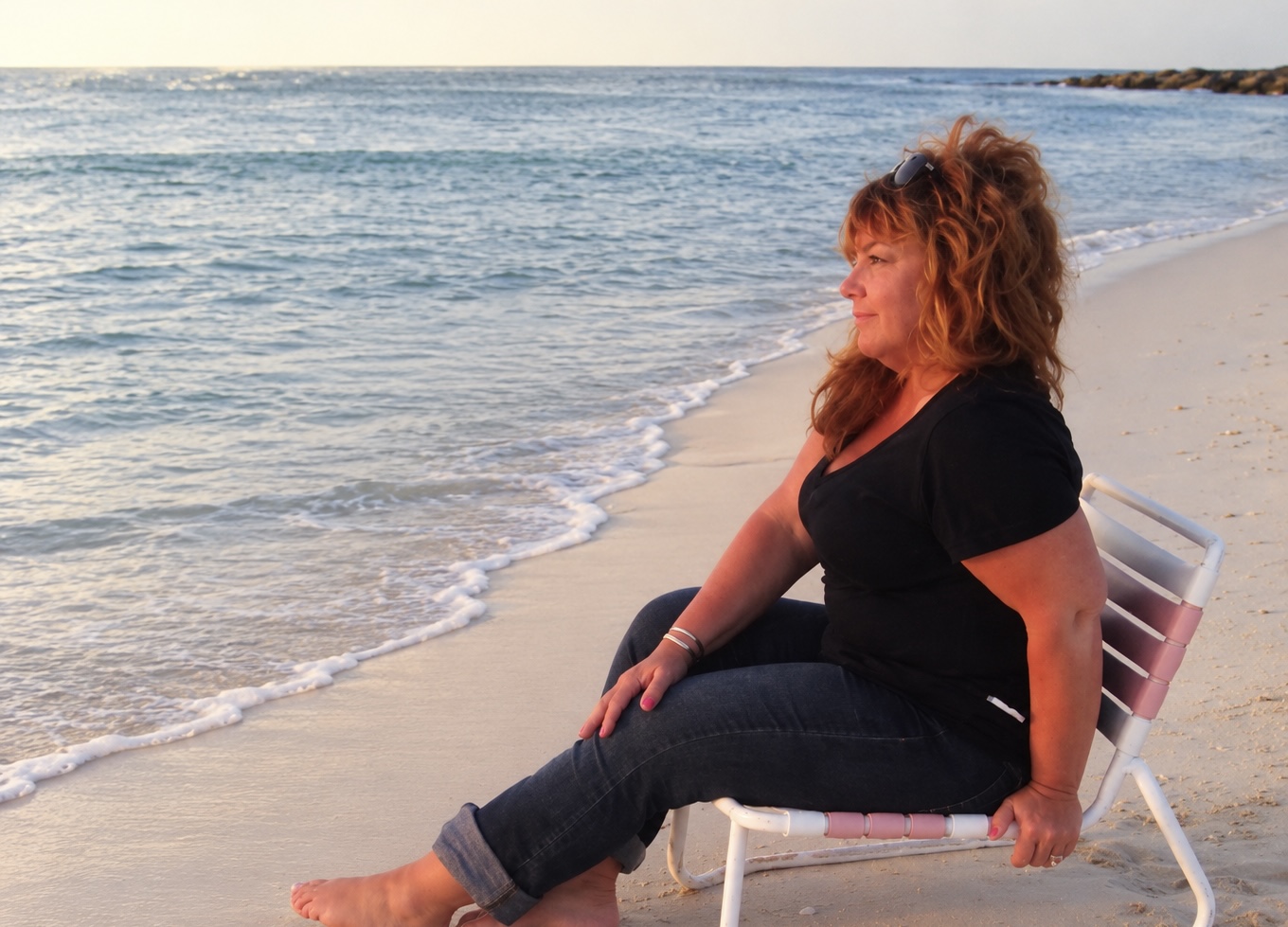 Anne Kelly Sousa sitting by the ocean