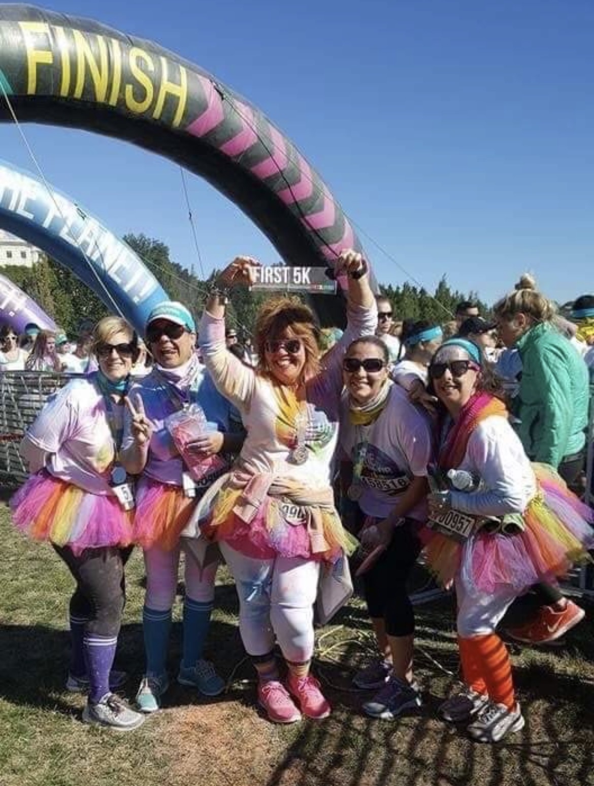 Anne celebrating her first 5K with friends at the finish line